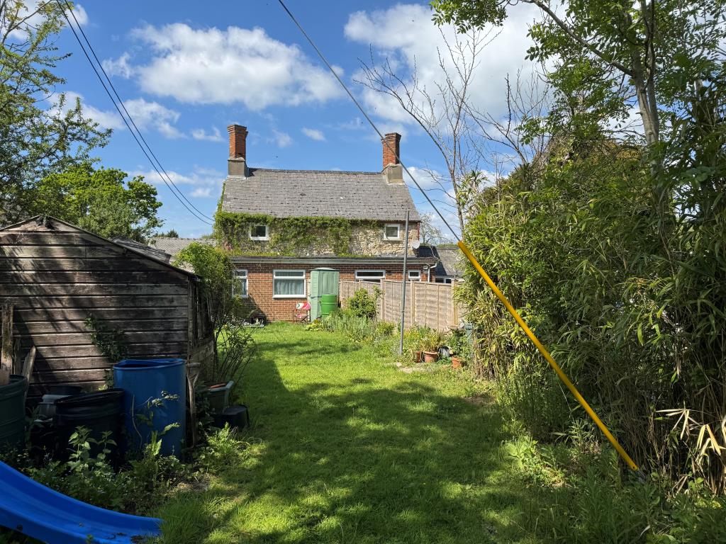 Lot: 102 - PAIR OF FREEHOLD COTTAGES IN A POPULAR VILLAGE LOCATION - Looking back at Cottage Two from the End of the Garden